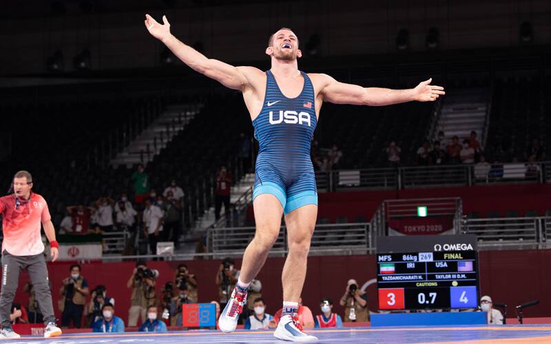 David Taylor spreads his arms wide after a win at the Olympic Games