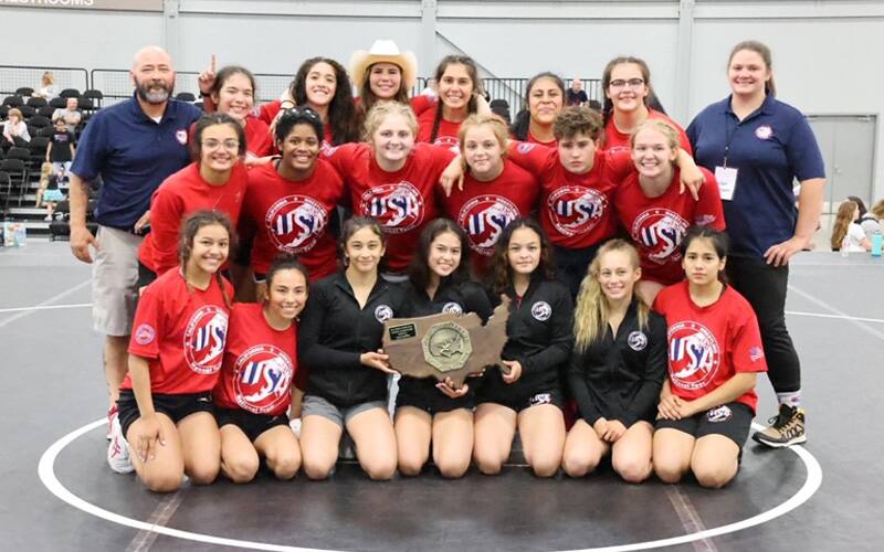 Team California, the 2021 Junior Women's National Duals champion, pose with their championship trophy