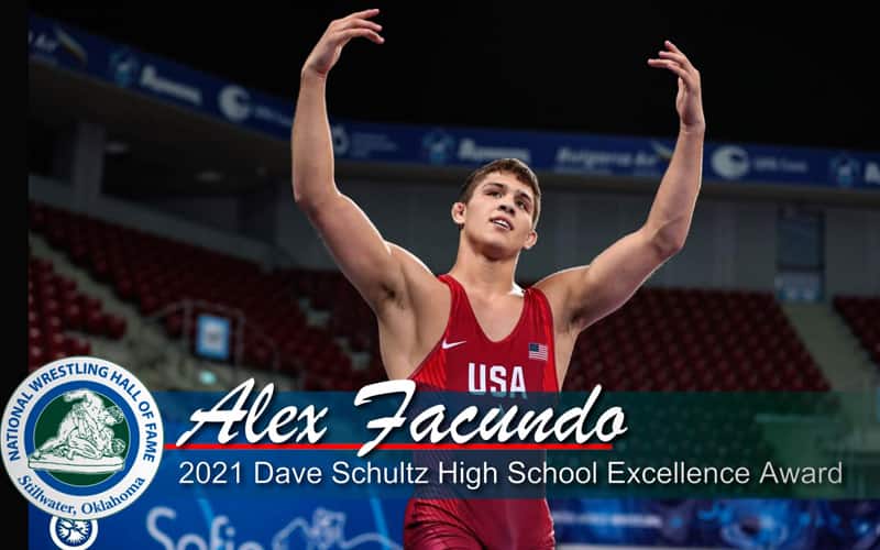 Alex Facundo raises arms after a victory, with a National Wrestling Hall of Fame logo in the graphic