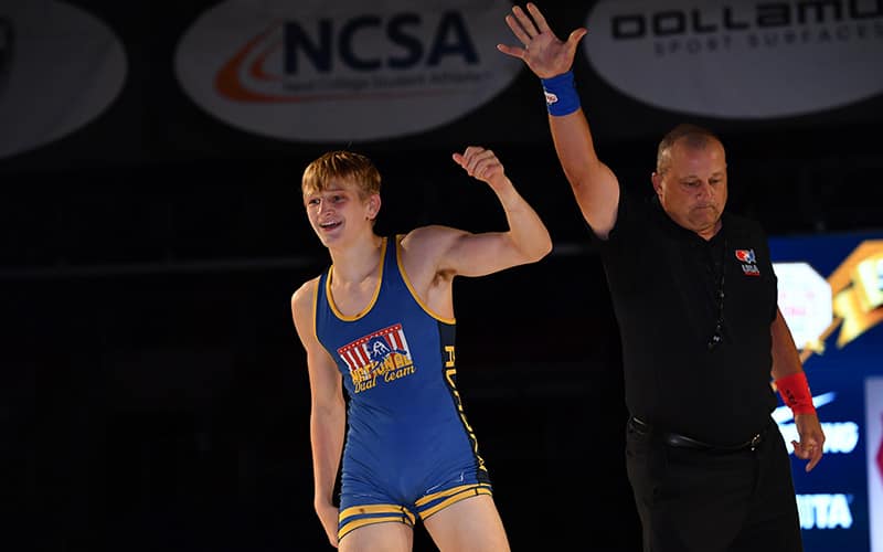 Jeremy Bockert of Alaska raises his hand after his finals match. 