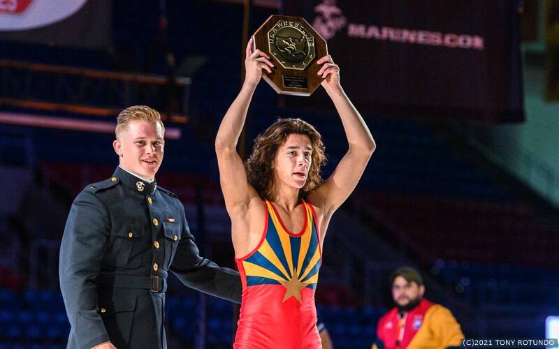 Kyler Larkin of Arizona holds aloft his USA Wrestling stop sign trophy as the 16U National champion