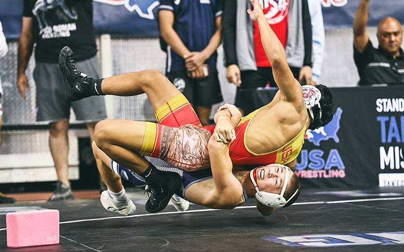 Zach Henson, Junior Freestyle champion, gut wrenches his opponent