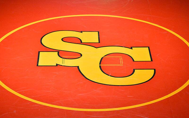 Simpson College logo on a wrestling mat