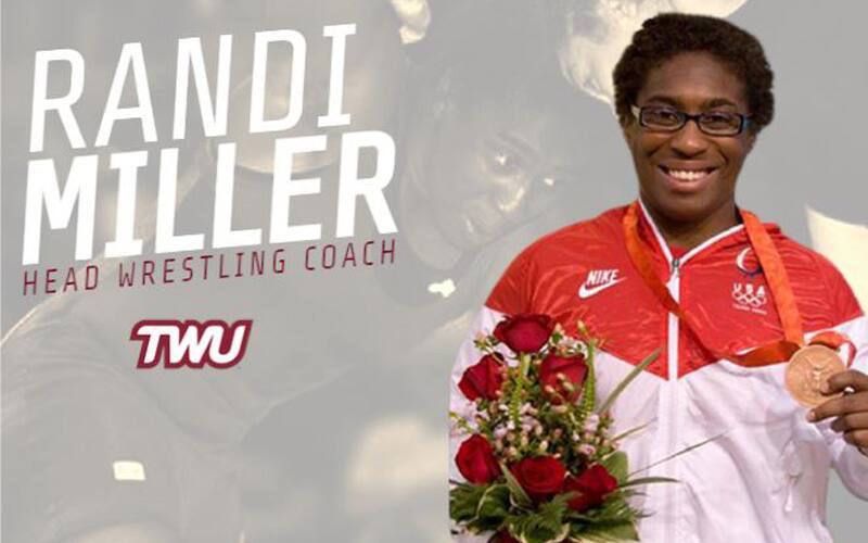 TWU women's wrestling coach Randi Miller holding her Olympic bronze medal