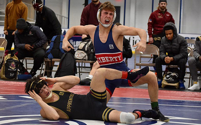Brandon Ahlemann of Liberty (149) celebrates a win at the NCWA National Duals. 