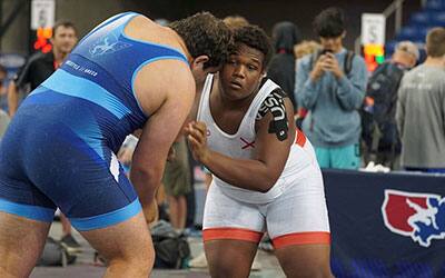 Heavyweight Willie Cox of Alabama (in white) advanced to the round of 16. He finished eighth last summer in the same weight. 