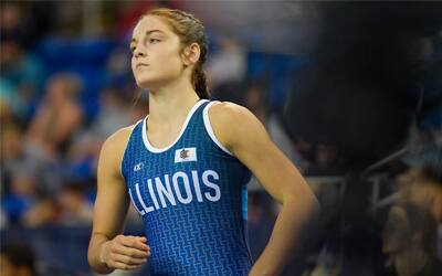 Cadence Diduch of Illinois in her blue singlet jogs across the mat. 