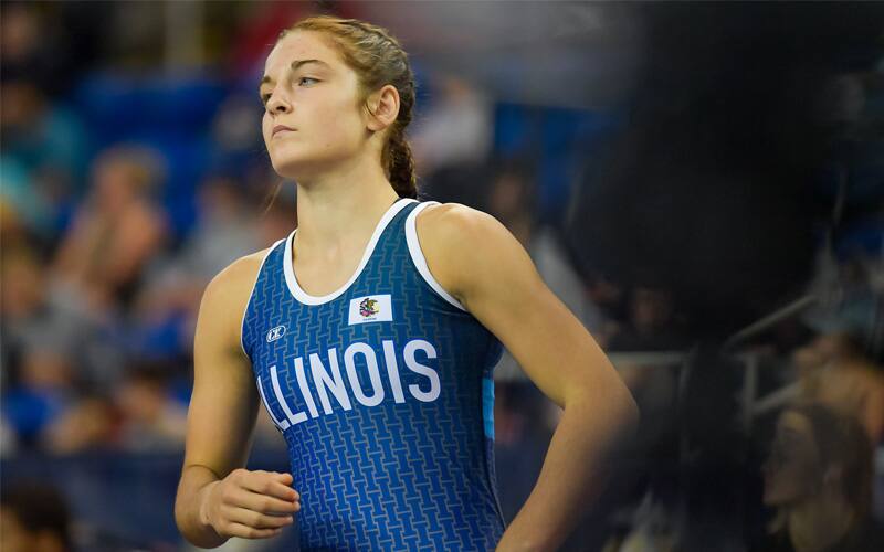 Cadence Diduch of Illinois in her blue singlet jogs across the mat. 