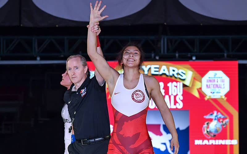 Savannah Gomez (CA) has her hand raised after winning 2021 Junior Nationals.