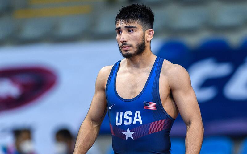 Randon Miranda looks out at the mat during a break in wrestling action