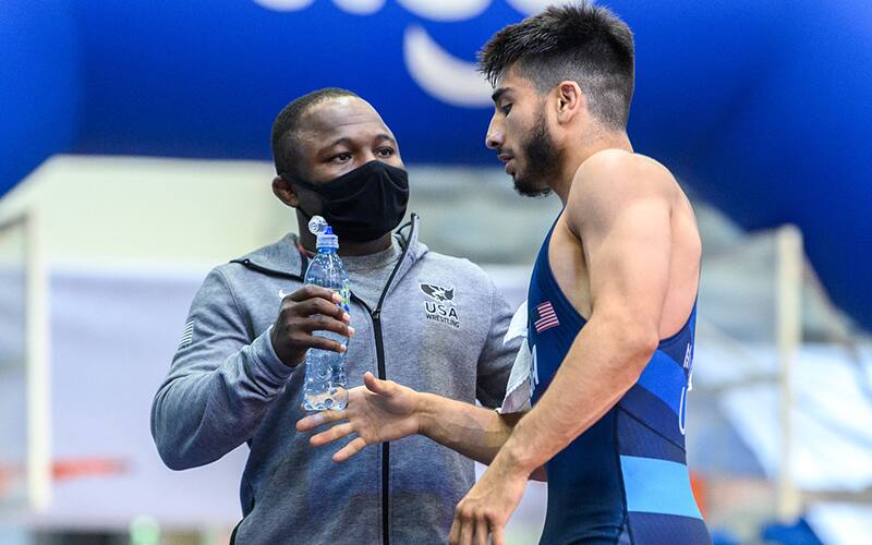 Randon Miranda talks with his corner during a break