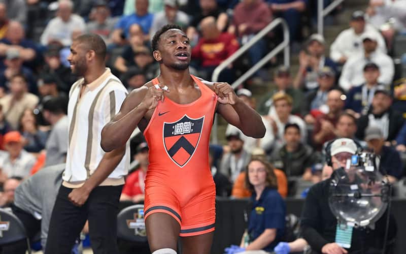 Quincy Monday (Princeton) shows off the logo on his singlet after winning NCAA semifinals.