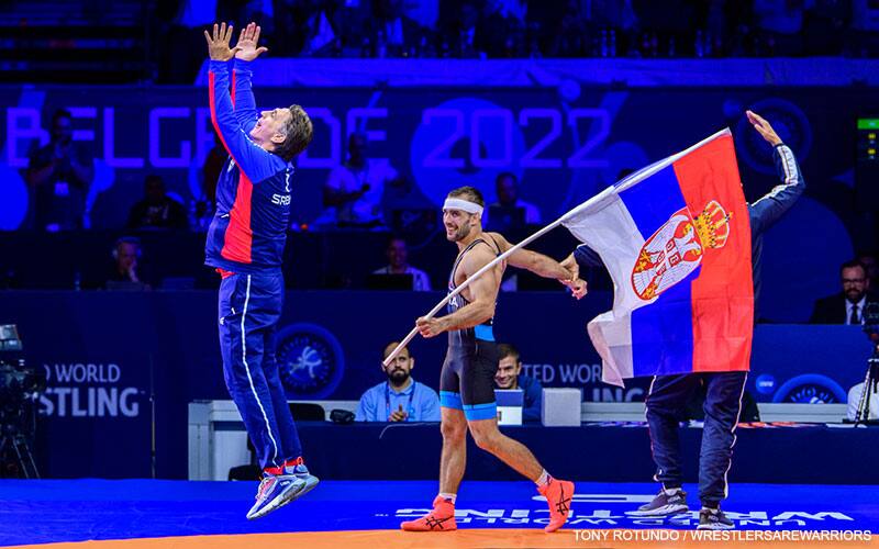 Serbian coach celebrates as World champion Mate Nemes carries the Serbian flag
