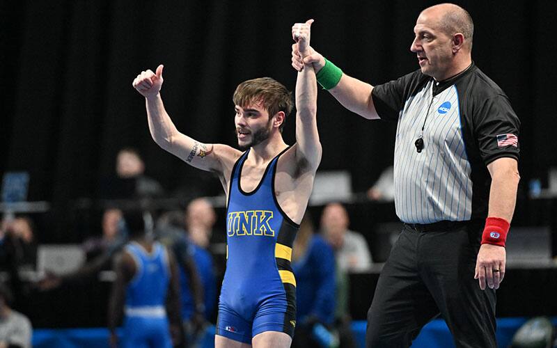 Josh Portillo of Nebraska-Kearney with his arm raised in victory at 2022 NCAA Div. II Nationals