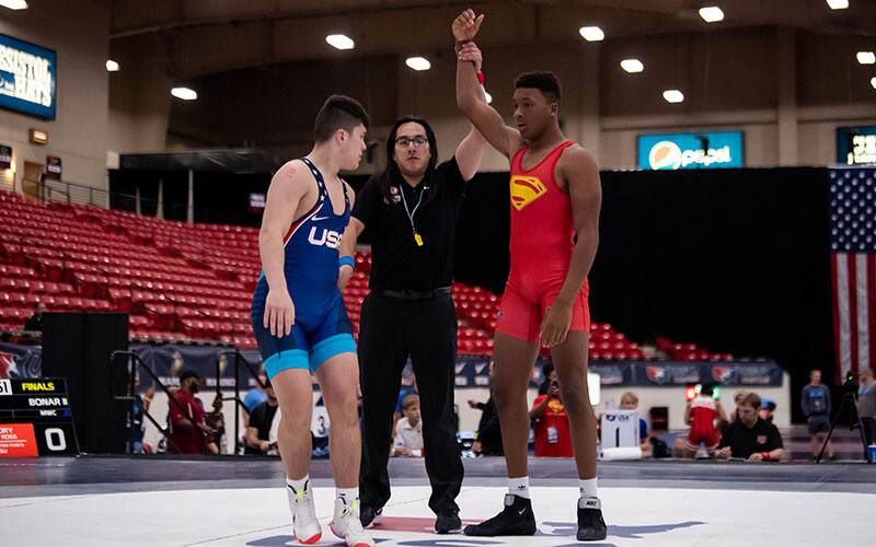 Dreshaun Ross (Sebolt Wrestling Academy) with arm raised at U15 Greco-Roman Nationals