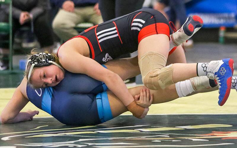 Emily Shilson (Augsburg) takes down an opponent.
