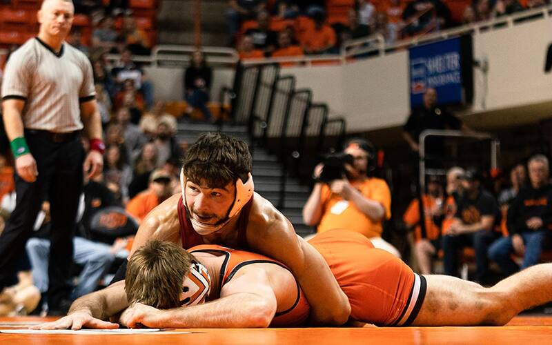 Iowa State wrestler rides an opponent during 2022's match against Oklahoma State