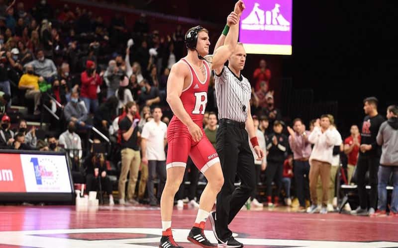Photo of a Rutgers wrestler getting his hand raised following a win