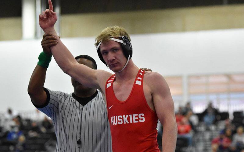 Image of St. Cloud State wrestler with arm raised in victory