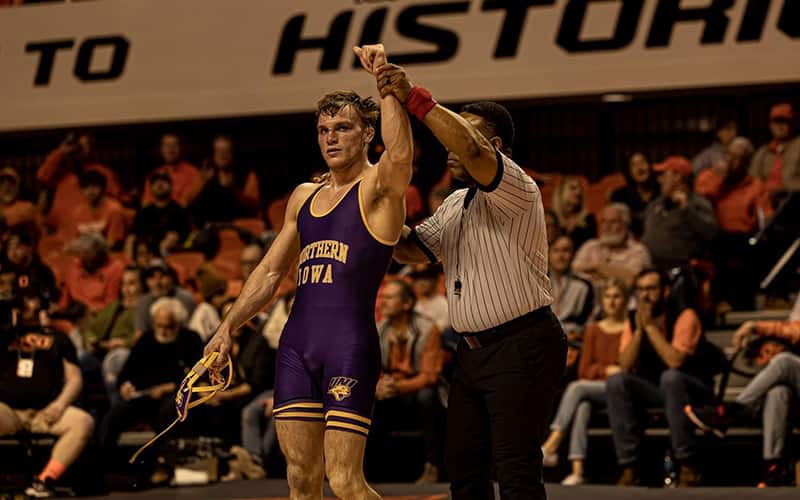 A UNI wrestler gets his hand raised after a win against Oklahoma State in Stillwater