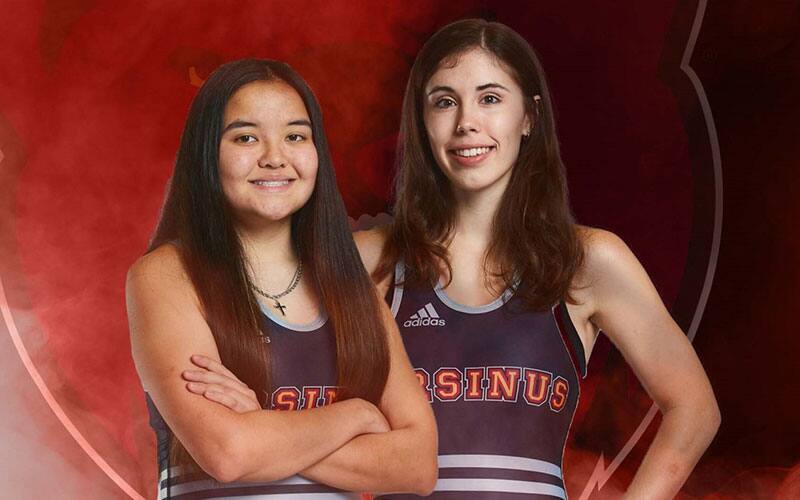 Two women wearing Ursinus wrestling singlets