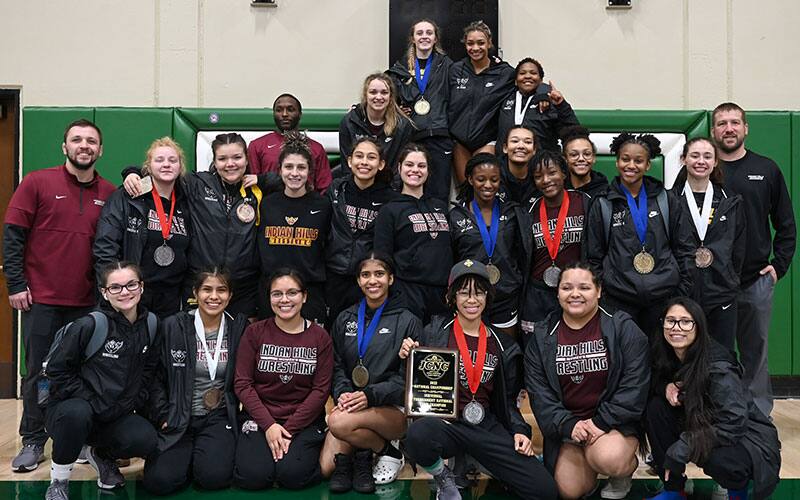 Indian Hills CC women's team pose together with JCNC national title trophies