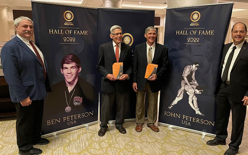 Ben and John Peterson (center) at UWW Hall of Fame induction, with USA Wrestling President Bruce Baumgartner (left) and Executive DIrector Rich Bender (right)