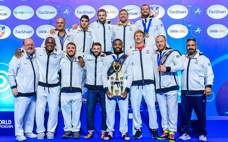 2022 U.S. Senior World Men's Freestyle Team poses with its World Championships first place trophy