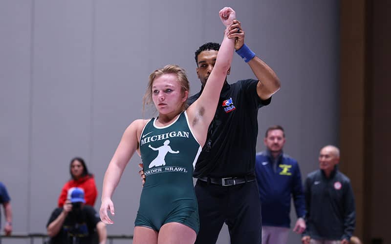 Cecelia Williams (MI) with arm raised in victory