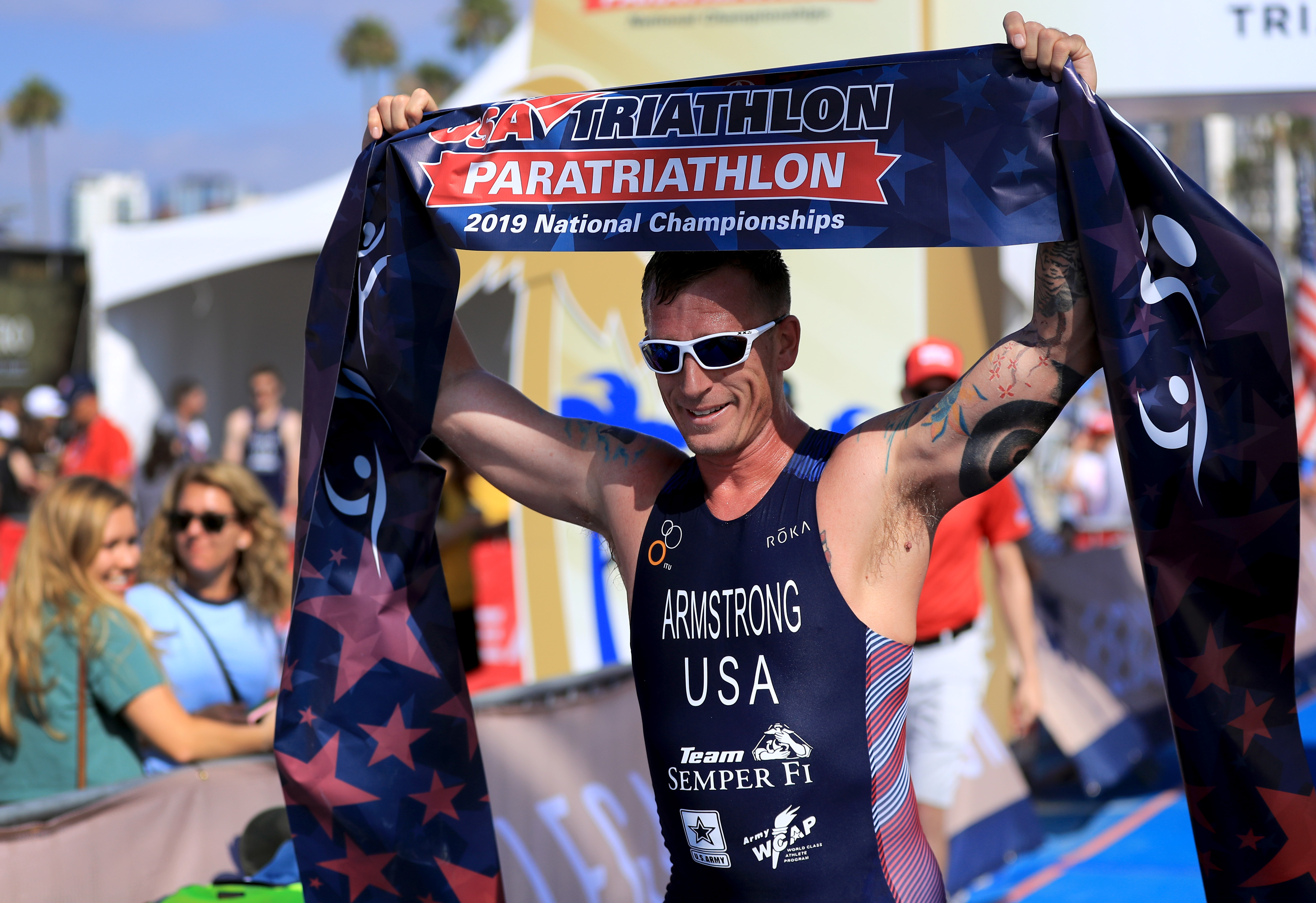 athlete holding finish banner